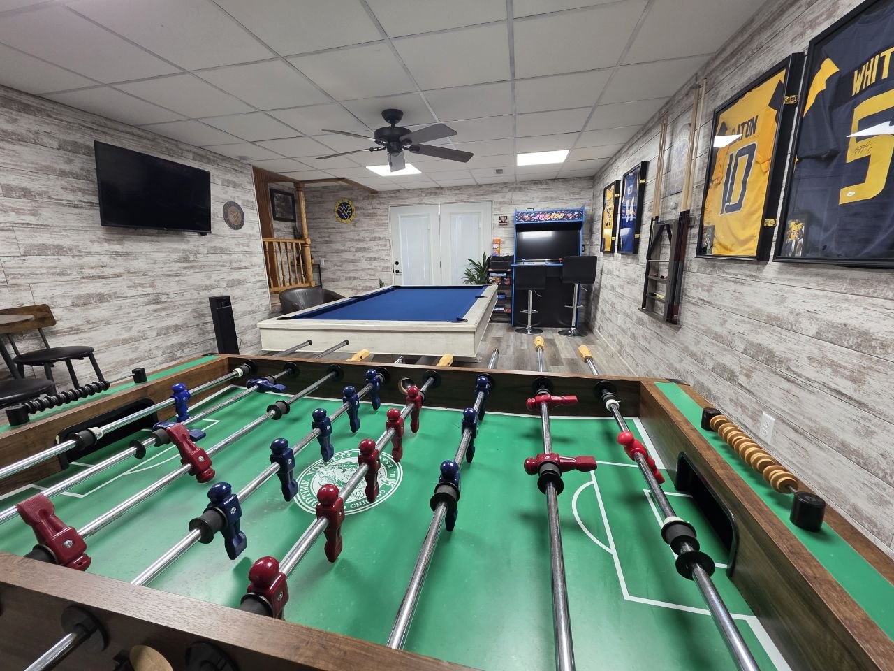 Foosball table and arcade games in vacation rental game room near WVU