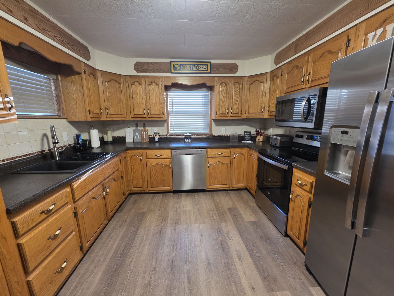 Full kitchen with WVU Mountaineers decor in vacation rental